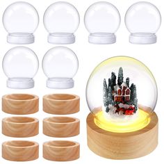 a snow globe with wooden base and eight clear glass balls surrounding it, all in front of a white background