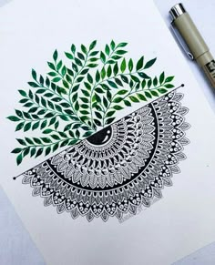 a drawing of a tree with green leaves on it next to a pen and paper