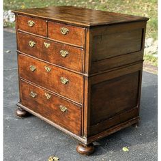 an old wooden dresser sitting on the sidewalk