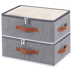 two grey storage boxes with brown leather handles