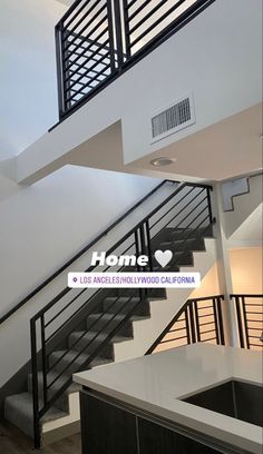 the stairs and railings in this modern home are painted white with black metal balconies