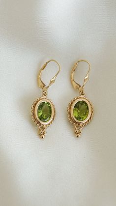 * Earring Material: Peridot, 14K Yellow Gold * Earring Dimensions: 1.5x0.5Inch * Stone Weight & sizes: Peridot - 4ct * Overall weight: 4.4g * Earring material: 14k yellow gold, Lever Back Peridot Gold Jewelry, Evry Jewels Earrings, Green And Gold Earrings, Peridot Rings, Peridot Jewelry, Peridot Earrings, Yellow Earrings, Classy Jewelry, Funky Jewelry