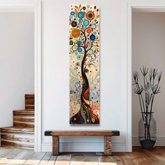 a painting hanging on the wall next to a wooden bench in a room with white walls