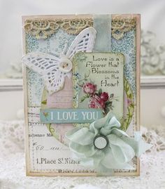 a close up of a card with flowers and a butterfly on it's side