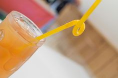 there is a drink with a yellow straw in it