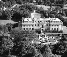 an aerial view of a large house surrounded by trees