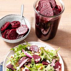 beet salad in a bowl next to a jar of pickled beets on a table