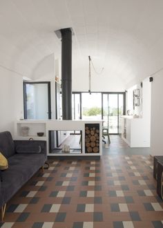 a living room filled with furniture and a fire place