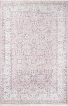 an antique rug with pink and white colors