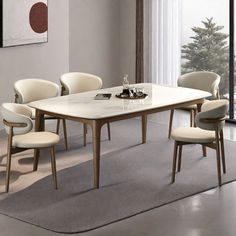 a dining room table with chairs around it and a rug on the floor next to it