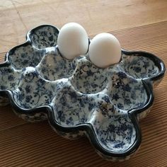 two eggs are sitting in an egg tray