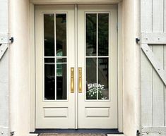 the front door to a house with two doors and sidelights on either side of it