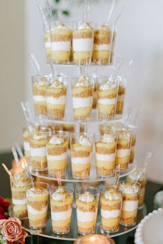 there are many desserts in cups on the table