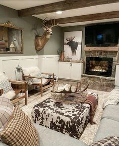 a living room filled with furniture and a deer head mounted on the wall above it