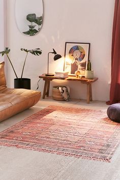 a living room filled with furniture and a rug on top of a wooden coffee table