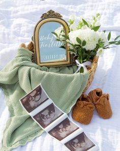 there is a basket with pictures and flowers on the bed