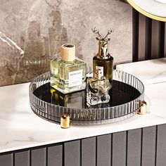 a tray with two bottles on it sitting on top of a counter next to a mirror