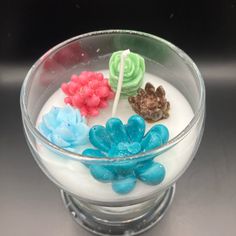 a glass bowl filled with different colored candies