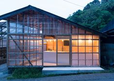 a small house with glass walls on the outside