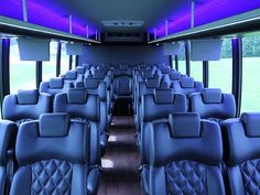 the interior of a bus with blue leather seats and purple lighting on it's ceiling