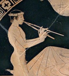 an ancient greek vase with a man playing the flute