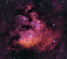 the large magel cloud in the sky is very bright and purple, with stars all around it