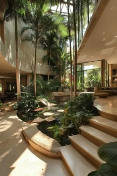 the inside of a house with lots of trees and plants on the stairs leading up to the second floor