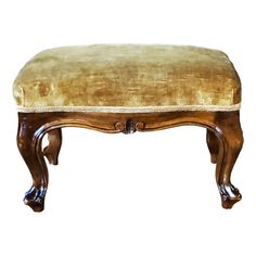 a wooden bench with gold velvet upholstered on the top and legs, against a white background