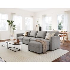 a living room filled with furniture and windows