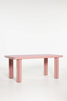 a pink table sitting on top of a white floor