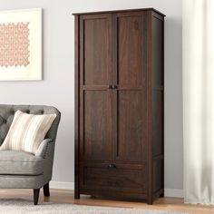 a chair and armoire in a living room