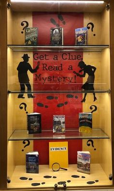 a display case with books on it and the words get a clue read a mystery