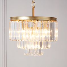 a chandelier hanging from the ceiling in a room with white walls and flooring