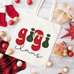 a tote bag sitting on top of a wooden floor next to christmas ornaments and decorations