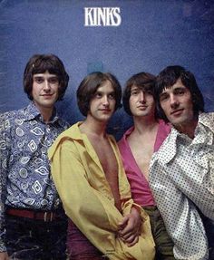 the kinks posing in front of a blue wall