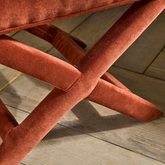 an orange chair sitting on top of a wooden floor