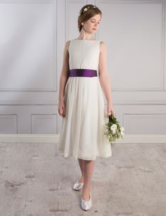 a woman in a white dress holding a bouquet