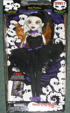 a doll in a black dress with skulls on it's head and wings,