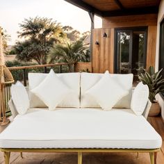 a white couch sitting on top of a wooden deck