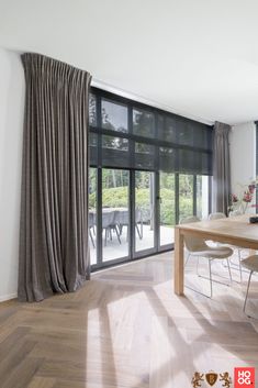 a dining room with wooden floors and sliding glass doors