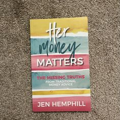 the book her money matters is laying on the carpet