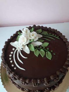 a chocolate cake with white flowers on top