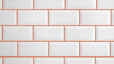 an orange and white tile wall with square tiles