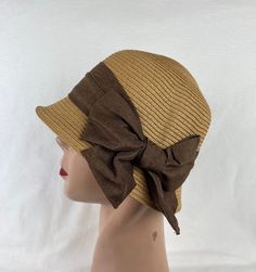 This soft Toyo Straw vintage-inspired cloche hat is lightweight and the hat will fit up to 22 5/8 inch head size which an inside sizing cord to adjust to your head size. The brim is 2 inches wide. The brim is about 4 1/2 inches tall. The bow band is made from cotton and linen blend material. NOTE: Please check the head size before purchase, I am happy to answer any questions you may have. There will be a 20% restocking fee for all returned hats. Adjustable Fedora Mini Hat For Church, Summer Cloche Sun Hat, One Size Fits Most, Brown Brimmed Cloche Hat One Size, Brown Brimmed Cloche Hat, One Size Fits Most, Brown Cloche Hat With Short Brim, Beige Cloche Hat For Church, Brown Brimmed Cloche Hat, Vintage Brown Hats For Beach, Adjustable Short Brim Boater Hat For Church