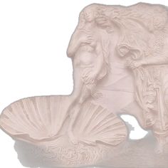 an intricately carved shell and mermaid figurine is displayed on a white background