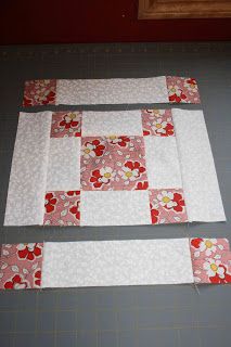 two pieces of fabric are laid out on the floor to be quilted into placemats