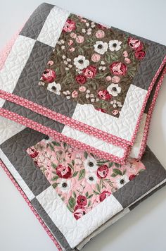 two quilted placemats on top of each other with flowers and polka dots