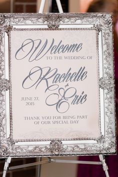 a welcome sign is hanging on a easel