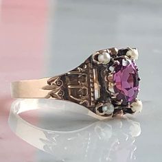 Details: Beautiful Victorian Garnet and Seed Pearl ring set in lovely 14K rose gold. The band is adorned in lovely abstract filigree engraving. The stone has great depth, and has a lovely rich pink tint to the garnet. It is surrounded by 4 seed pearls. The garnet measures 7.5mm x 5mm. There are no internal markings. Measurements: Ring measures a size 7 3/4 US. It can be re-sized for a fee. Condition: The overall all condition of this ring is very good. Please ask all questions prior to placing a Victorian Antiques, Antique Rings Vintage, Seed Pearl Ring, Antique Wedding Rings, Antique Wedding, Animal Coloring, Victorian Rings, 14k Rose Gold Ring, Ancient Jewelry