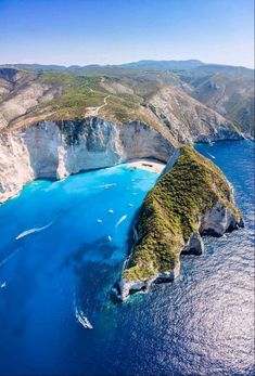 an aerial view of the blue waters and cliffs